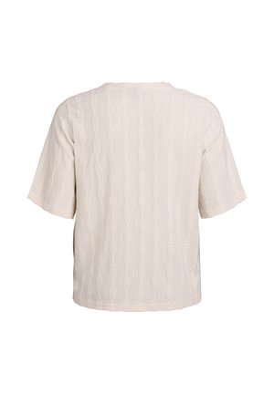 Lys beige top med korte ærmer og et tekstureret knudemønster over det hele. Løs pasform og rund halsudskæring.
