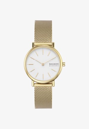Reloj de pulsera Skagen en tono dorado con esfera blanca, marcadores horarios dorados, correa de malla y diseño minimalista que muestra la hora 10:10.