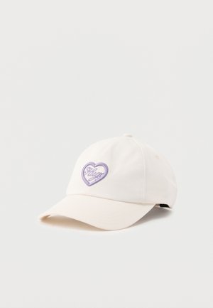Gorra blanca de béisbol con un logo morado en forma de corazón y texto en cursiva en el frente, mostrada sobre un fondo claro y liso.