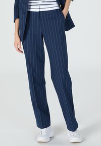 Navy pinstriped trousers made from a lightweight fabric, featuring a straight leg design and a waistband with subtle detailing.