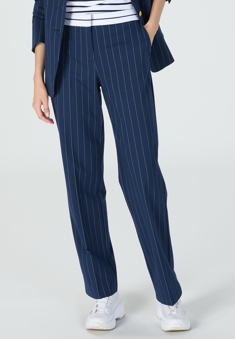 Navy pinstriped trousers made from a lightweight fabric, featuring a straight leg design and a waistband with subtle detailing.
