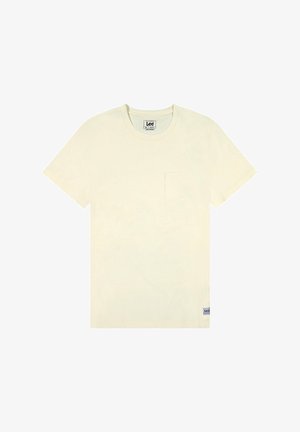 Kremowa bawełniana koszulka z klasycznym dekoltem okrągłym, krótkimi rękawami i pojedynczą kieszenią na piersi. Posiada małą metkę marki na dole.