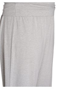 Light grey joggers made of soft, stretchy fabric. Features a wide waistband and side seam detailing for a relaxed fit.