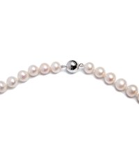 Pearl necklace featuring round, white pearls with a smooth finish and silver magnetic clasp. Pearls are uniform in size and sheen.