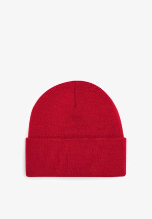 Red knit beanie hat with a folded cuff. Made from soft, textured material. Simple, rounded shape with no additional patterns or accents.