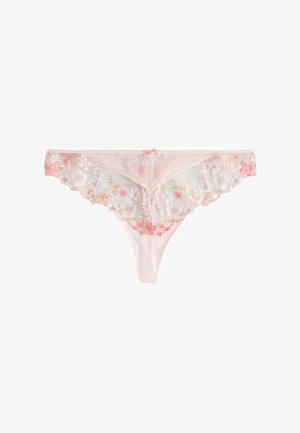 Sheer beige lace thong with floral embroidery in white and pink, featuring a small pink bow at the waistband center.