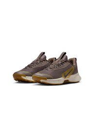 Nike sneakers in brown mesh with a textured surface, yellow logo accent, and speckled outsole, featuring a cushioned sole and lace-up design.