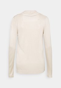 Beige långärmad tröja med rund halsringning och ribbad textur. Enkel design utan synliga mönster eller hårdvarudetaljer.