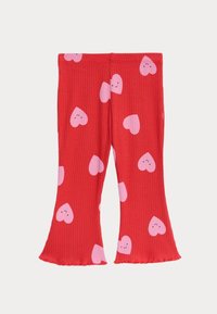 Røde ribbede leggings med en udvidet kant og et mønster af lyserøde hjerter og smilende ansigtstræk. Blødt stof med en strækbar talje.