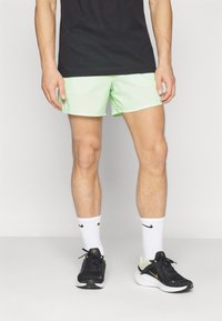 Nike Performance STRIDE - Sports shorts - vapor green/dark stucco/reflective silver