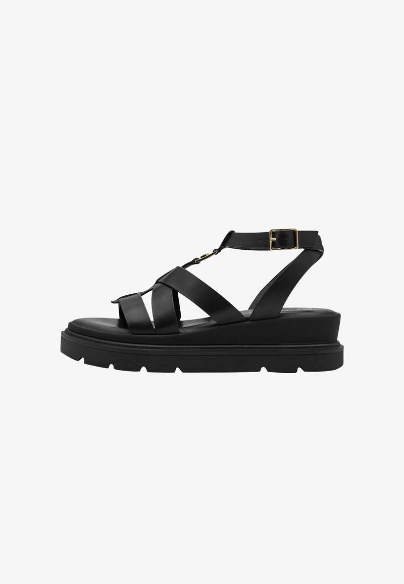Sandales noires en cuir avec des brides croisées, une boucle décorative et une semelle plateforme épaisse avec une bande de roulement texturée.