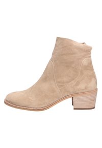 Stivale alla caviglia in suede beige con forma affusolata, tacco basso e impilato, e trama liscia. Presenta cuciture minime e colletto morbido.