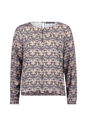 Chemisier à manches longues en tissu léger, présentant un motif géométrique dans des tons de bleu, beige et gris avec une fermeture en forme de clé à l'arrière.