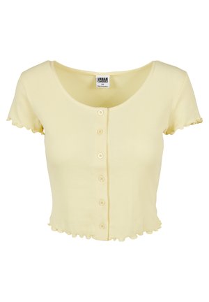 Kortærmet, lysegul ribbet crop-top med en rund udskæring, fem knapper ned langs fronten og flæser i kanterne ved ærmerne og kanten.