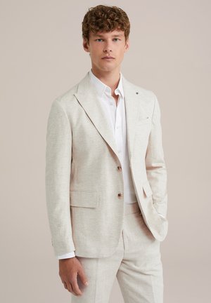 Beige linen suit jacket with notched lapels, single button closure, and two front pockets. Worn over a white shirt. Smooth texture.
