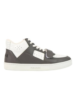Low-top black and white leather sneaker with laces and a Velcro strap, featuring "CELINE" embossed on the white sole.