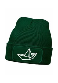 Green knit beanie with a folded cuff, featuring a white graphic of a paper boat on a patch. Textured fabric with ribbed design.