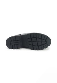 Black rubber outsole with textured tread pattern. Features a rounded toe and cushioned heel for support. Brand name is embossed in the center.