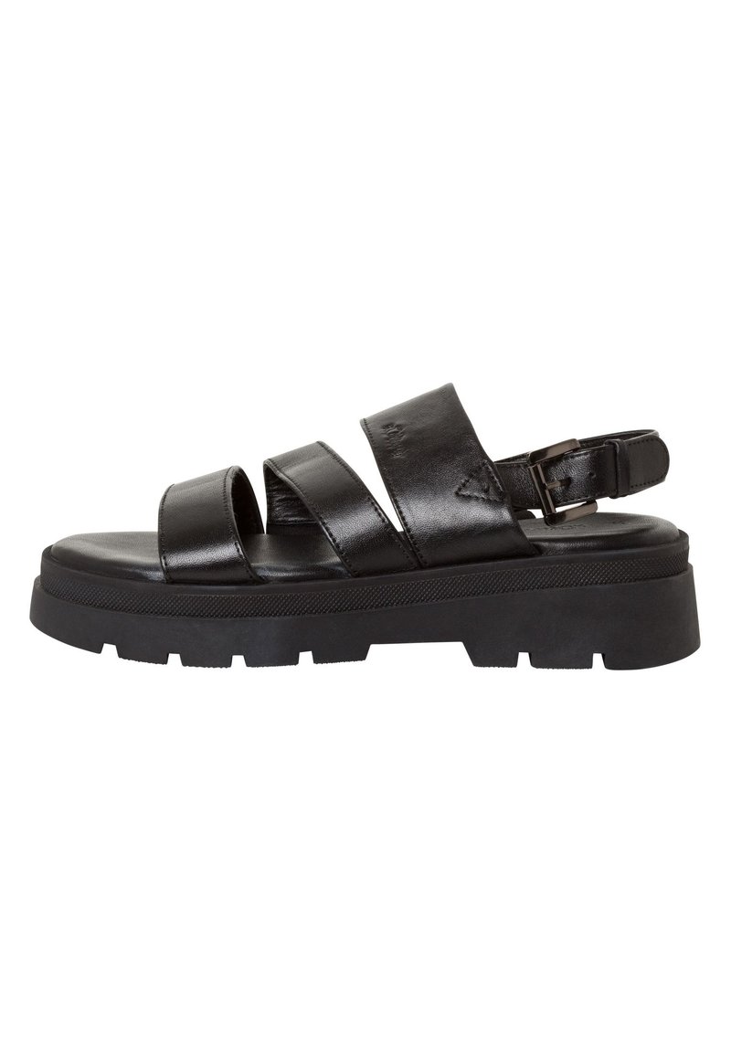 Black leather sandals with three wide straps, adjustable ankle buckle, and a chunky treaded sole. Smooth texture and minimalist design.