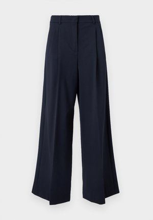 Tumši zili plataji bikses ar priekšējām krokām, jostas cilpām un noslēptu priekšējo aizdari.