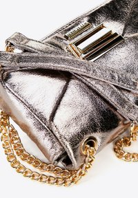 Metallic silver handbag with a textured finish, featuring a gold chain strap and a decorative gold hardware accent on the front.