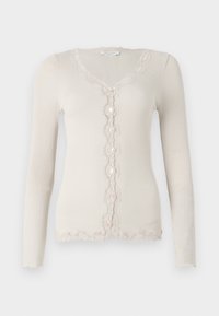 Beige ribbed cardigan with long sleeves, V-neckline, five button closure, and scalloped lace trim along the edges and placket.