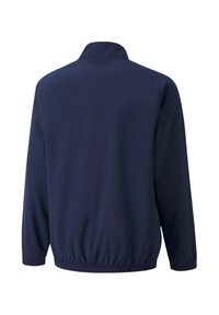 Marineblauwe windbreakerjack, lichtgewicht materiaal, elastische tailleband, hoge kraag en lange mouwen met elastische manchetten.