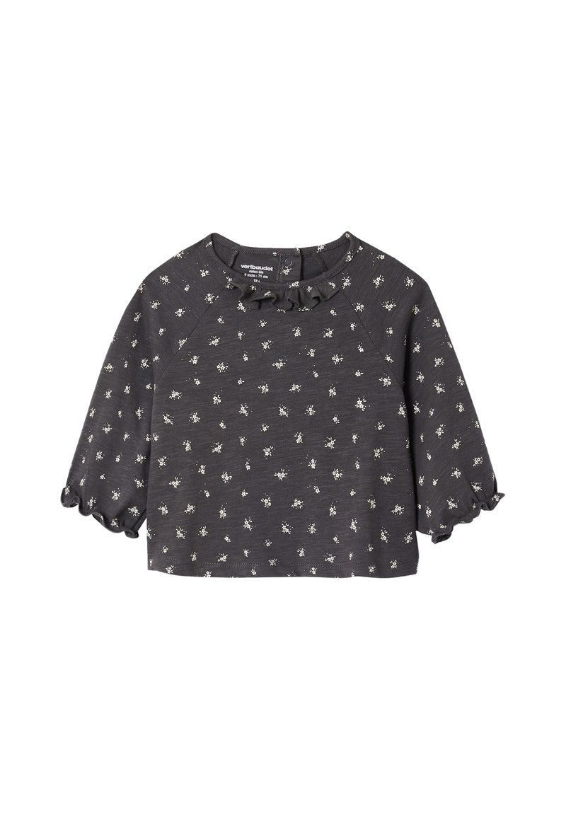 Dark gray short-sleeve top with a ruffled neckline and white floral patterns. Soft fabric with a relaxed fit and slightly flared sleeves.