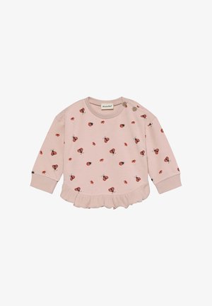 Maglietta rosa chiaro a maniche lunghe con orlo arricciato, caratterizzata da un motivo con coccinelle rosse e piccoli dettagli neri. Due bottoni sulla spalla.