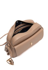 Beżowa skórzana torebka na ramię z złotymi okuciami, wyposażona w zamknięcie na suwak, podwójne przegródki oraz teksturowaną powierzchnię.
