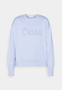 Sweatshirt albastru deschis cu mânecă lungă. Prezentă un gât rotund și logo-ul 'Casall' brodat cu fir contrastant. Textură de stofă moale.