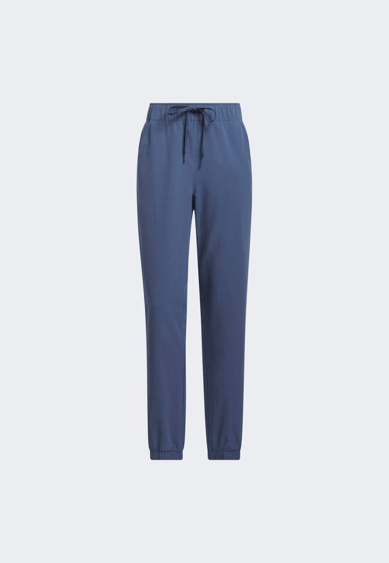 Jogging en bleu marine, fuselé, fabriqué dans un tissu lisse. Comprend une taille élastique avec un cordon de serrage et des poignets côtelés aux chevilles.
