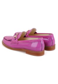 Roze gepatineerde leren loafer met een lage bruine houten hak, voorzien van een gouden ritsdetail en een klassiek gestikt te ontwerpen.