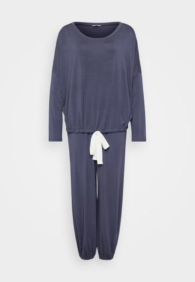 Navy jumpsuit with long sleeves, a relaxed fit, elastic waistband, and a white tie detail at the waist. Soft, lightweight fabric.