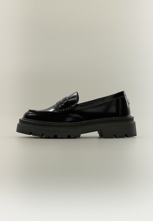 Black shiny leather loafer with thick lug sole and penny strap detail, shown from the side on a plain neutral background.