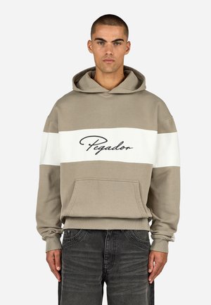 Hooded sweatshirt in beige and white with a front pocket. Features a black script logo "Pegador" across the chest. Made from soft material.