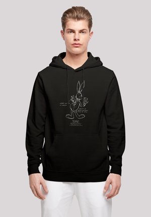 Svart hettegenser med en frontlomme, prydet med en hvit grafikk av Bugs Bunny, inkludert komisk stil tekst og detaljer. Laget av bomull.