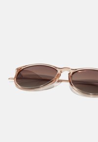 Brown-tinted oval sunglasses with a transparent pale pink frame and metal accents, featuring a sleek design and smooth texture.