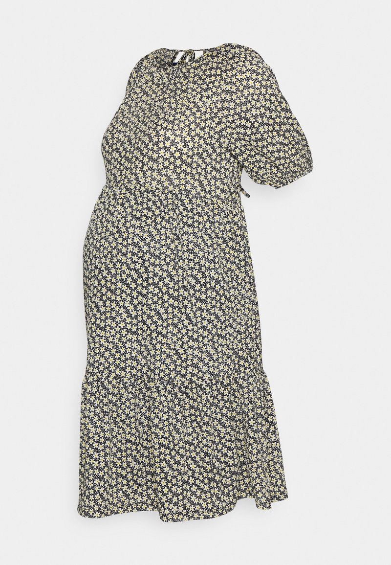 Robe de maternité avec un fond bleu marine, petit motif floral blanc et jaune, manches courtes bouffantes, encolure ronde et ourlet froncé.