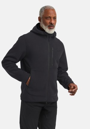 Zwarte geribbelde zip-up hoodie met een hoge kraag, capuchon en zijzakken. Beschikt over een horizontale naad en een ritsvak op de borst.