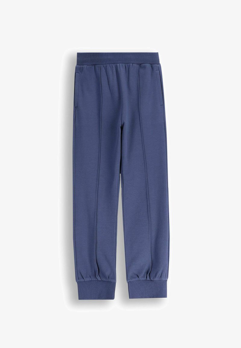 Niebieskie dresowe spodnie z bawełny z elastycznym paskiem w talii, bocznymi kieszeniami i ściągaczami przy kostkach, wyłożone płasko na białym tle.