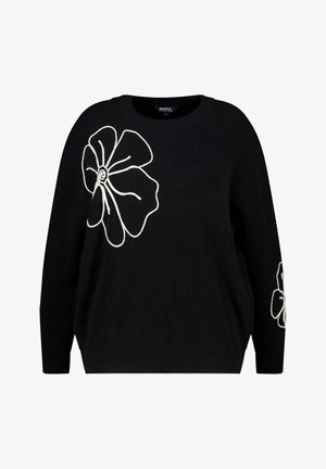 Zwarte gebreide sweater met witte bloembroderie op de voorkant en mouwen. Het heeft een losse pasvorm en een geribbelde textuur.