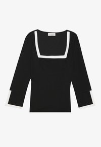 Haut noir à encolure carrée, avec des accents blancs sur le col et les manches, en tissu lisse, doté de manches longues avec des poignets contrastants.