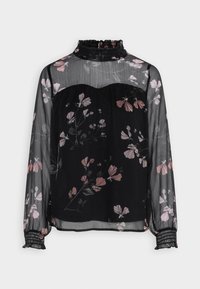 Blouse noire et transparente avec un motif floral aux tons roses. Présente un col à volants et des poignets élastiqués. Coupe ample et fluide.