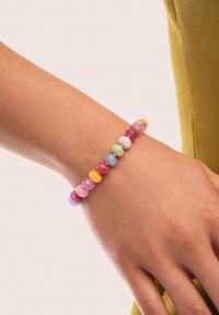 Bracelet en perles colorées composé de diverses perles rondes en rose, violet, bleu, vert, jaune et orange, avec de petites accents dorés entre les perles.