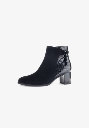 Black ankle boot with a combination of smooth suede and glossy crocodile-embossed details. Features a square heel and decorative side cutouts.