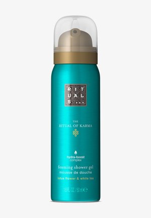 Canistre en métal turquoise avec un capuchon en plastique transparent. Présente des accents dorés et du texte. Contient 50 ml de gel douche moussant à la fleur de lotus et au thé blanc.