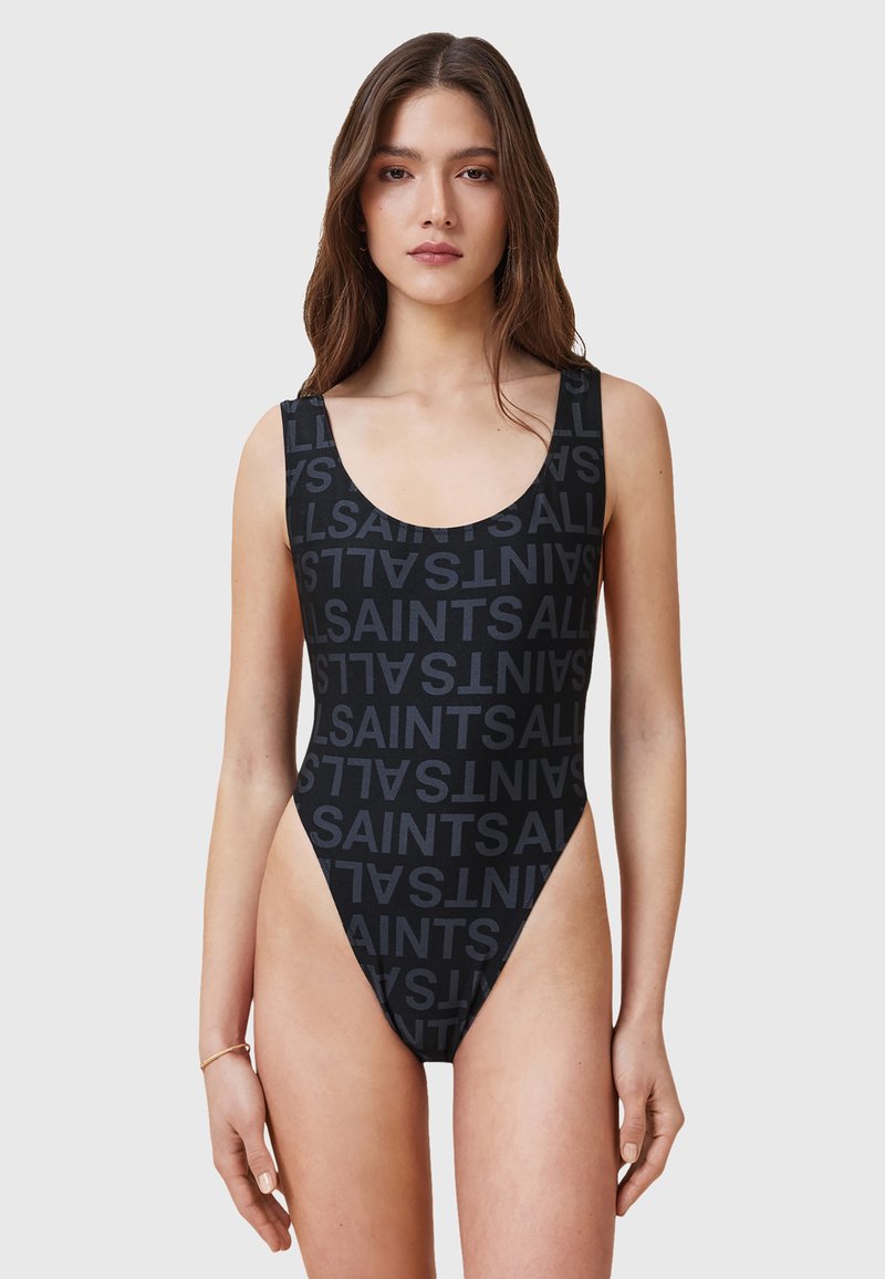 Costume intero nero con motivo ripetuto "SAINTS", scollatura a barca e gambe alte. Realizzato in tessuto morbido ed elasticizzato.