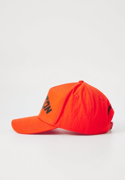 Orange cap with a curved visor, made of cotton. Features a black printed text on the front, adjustable strap at the back.