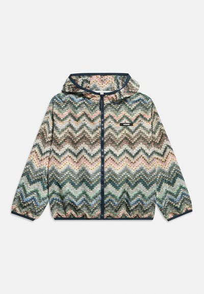 Veste légère à capuche zippée avec motif zigzag multicolore et poignets élastiques, avec une petite étiquette de marque sur la poitrine.